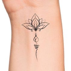 a woman's wrist with a tattoo design on the left side of her arm