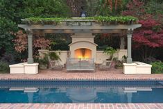 an outdoor fireplace in the middle of a swimming pool