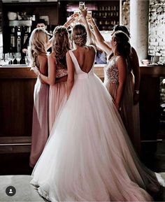 the bride and her bridesmaids are getting ready to go into their wedding ceremony