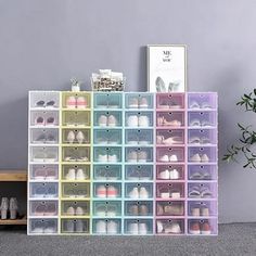 the shoe rack is filled with many pairs of shoes and has multiple bins on each side