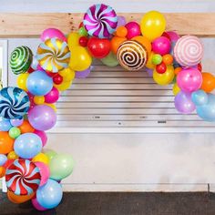 an arch made out of balloons and lollipops