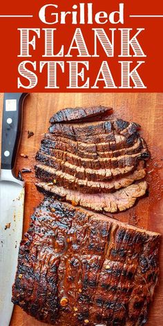 grilled flank steak on a cutting board with a knife and fork next to it