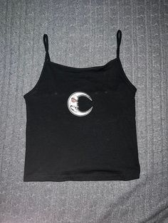 Size S black spaghetti strap baby tank with grunge moon patch. Made of cotton, recycle polyester, and spandex. Black Cotton Tank Top, Trendy Black Top With Moon Print, Y2k Black Tank Top With Tank Straps, Y2k Style Black Cami Tank Top, Black Y2k Tank Top, Black Cotton Spaghetti Strap Top, Y2k Black Camisole With Spaghetti Straps, Black Cami Tank Top Y2k Style, Black Cotton Tank Camisole