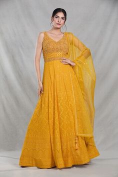 Mango yellow sleeveless full length gown with Mughal bloom embroidery using thread, sequin, beads and cutdana highlights. Paired with a ditsy sequin floret work dupatta. - Aza Fashions Anarkali Style Sleeveless Gown With Dupatta, Sleeveless Georgette Gown For Wedding, Traditional Yellow Sleeveless Anarkali Set, Yellow Sleeveless Dresses For Reception, Yellow Anarkali Set With Chikankari Embroidery For Reception, Sleeveless Anarkali Set With Chikankari Embroidery For Wedding, Fitted Sleeveless Anarkali Set For Reception, Sleeveless Georgette Dress With Zari Work, Traditional Sleeveless Gown With Dupatta