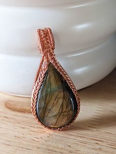 Introducing our exquisite Wire-Wrapped Triquetra Pendant, a harmonious fusion of ancient symbolism and natural beauty. Crafted with precision and passion, this pendant showcases a mesmerizing labradorite cabochon embraced by meticulously handcrafted copper wire. Labradorite Cabochon: The heart of this pendant is a stunning labradorite cabochon, a gemstone known for its ethereal play of colors. With each movement, labradorite reveals an ever-changing array of iridescent hues, casting a spellbindi Triquetra Pendant, Celtic Traditions, Clay Face Mask, Ritual Tools, Wire Wrap Pendant, Cycle Of Life, Labradorite Cabochon, Red Cat, Stacked Jewelry