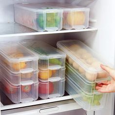 a person is reaching for food in the refrigerator