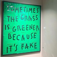 a green sign that says sometimes the grass is greener because it's fake