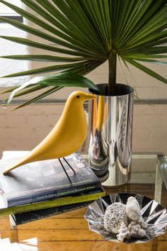 a table topped with two vases filled with plants