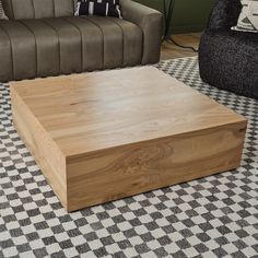 a coffee table sitting on top of a checkered floor next to a couch and chair