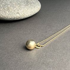 Made of solid 14k gold, our sphere charm symbolizes completeness and connection for those who wear it. It embodies the essence of our Golden Geometry collection, showcasing the beauty of form, the precision of mathematics, and the timeless allure of nature's perfect shapes. the Sphere pendant is available in solid 14k gold + sterling silver all charms come on a 14k gold ball chain necklace pendants are first hand carved in wax and then cast in either 14k gold or sterling silver perfect for every Gold Pendant Necklace With Ball Chain, Minimalist Round Ball Chain Jewelry, Minimalist Jewelry With Round Pendant Ball Chain, Yellow Gold Pendant Charm Necklace With Satellite Chain, Minimalist Jewelry With Ball Chain And Round Pendant, Sterling Silver Pendant Necklace With Ball Chain, Minimalist Necklace With Rolo Chain And Round Pendant, Elegant Orb-shaped Sterling Silver Necklace, Minimalist Yellow Gold Ball Chain Jewelry