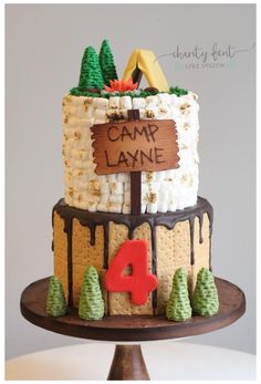 a cake that is sitting on top of a wooden stand with the name camp lane written on it