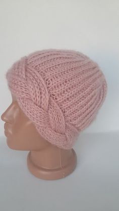 a pink knitted hat on a mannequin head