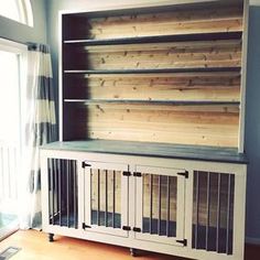 a wooden bookcase with metal bars on the top and bottom, in front of a window