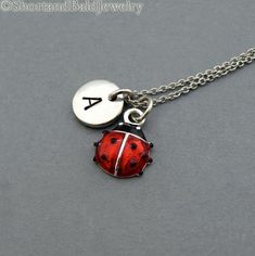 * Ladybug charm in Silver plated and hand enameled. Approx: 7/16”* Hand Stamped Initial Charm - Antique Silver Pewter  3/8" (9mm)* Chain length - 16", 18", 20"* Add a birthstone or Freshwater pearl for $3.50https://www.etsy.com/listing/110444872* Additional Hand Stamped Initial Charms $4.50 each:https://www.etsy.com/listing/107021419* Go back to Short and Bald Jewelry http://www.etsy.com/shop/ShortandBaldJewelry* Your purchase will arrive attractively packaged and ready to give. Ladybug Necklace, Ladybug Jewelry, Lady Beetle, Necklace Initial, Couple Jewelry, Funky Jewelry, Personalized Monogram, Dream Jewelry, Initial Charm