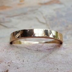 "To create this humble, minimalist band, I start with thick, solid 14k gold wire that I join to form a perfect circle, then hammer for a subtle texture. This band is hand polished for high shine, but can also be made with a matte finish upon request (select color and finish from drop down menu at checkout). Each band measures just over 3mm wide and 1.5mm thick, and is joined with 14k cadmium free, color match, plumb-gold solder to ensure a seamless join and the highest possible gold content. Rin Hammered 14k Gold Stackable Rings, Simple Hammered 14k Gold Rings, Minimalist Hammered 14k Gold Stackable Rings, Minimalist Hammered Yellow Gold Rings, Minimalist Hand Forged Wide Band Jewelry, Minimalist Hammered Stackable Rings In Recycled Gold, Minimalist Hammered Wide Band Jewelry, Hand Forged 14k Gold Stackable Rings With Round Band, Hand Forged Stackable 14k Gold Rings With Round Band