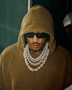 a man wearing sunglasses and a hoodie