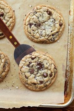 chocolate chip cookies on a baking sheet with a spatula