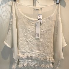 New With Tags Boho / Festival Oversized Sheer High/Low Embroidered Cropped Tassel Trim Crop Measuring 24 Inches Across The Chest, 15 Inches From Shoulder To Hem In The Front, 19 Inches From Shoulder To Hem In The Back, 33 Inches Across From Top Top Of Right Sleeve To Top Of Left Sleeve. Flowy Embroidered White Tops, Flowy White Embroidered Top, Embroidered Bohemian Lace Top For Summer, Festival Lace Tops With Short Sleeves, Summer Short Sleeve Blouse With Tassels, Summer Blouse With Tassels And Short Sleeves, Bohemian Embroidered Lace Top For Summer, Flowy Embroidered Top For Summer, Beach Lace Blouse With Floral Embroidery