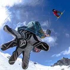 a man flying through the air while riding skis on top of snow covered ground