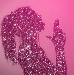 a woman's silhouette is covered in pink glitter and holds her hand up to the side