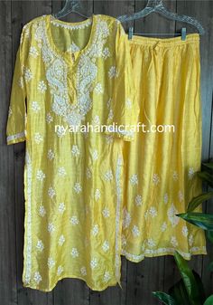 "Chikankari kurta on cotton silk with matching palazzo. Trendy \"ghaas patti\" embroidery ! Matching liner included. Embroidery designs may vary." Chanderi Palazzo Set With Chikankari Embroidery For Navratri, Navratri Chanderi Palazzo Set With Chikankari Embroidery, Floral Embroidered Mulmul Sharara For Festivals, Traditional Mulmul Palazzo Set With Floral Embroidery, Diwali Embroidered Mulmul Palazzo Set, Embroidered Mulmul Palazzo Set For Navratri, Yellow Chikankari Embroidery Sets For Diwali, Yellow Mulmul Palazzo Set With Cutdana Details, Yellow Mulmul Palazzo Set With Cutdana