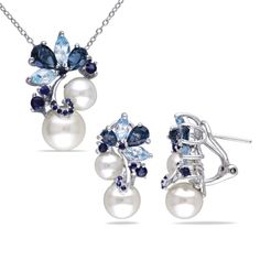 Make all her dreams come true with this gorgeous multi-stone London-Blue Topaz, Sky-Blue Topaz, Sapphire and White Freshwater Cultured Pearl 2-piece jewelry set. Crafted in sterling silver, this classic earring and pendant set features six single-cut, cultured-set freshwater cultured pearl with six pear-cut, prong-set London Blue topaz gemstones and six marquise-cut, prong-set sky-blue topaz gemstones surrounding them. An additional twelve round-cut, prong-set and thirteen round-cut, pave-set sa Pearl Cluster Earrings, Blue Sapphire Pendant, Blue Topaz Pendant, Gem Earrings, Silver Jewellery Sets, Sapphire Pendant, Sky Blue Topaz, Sapphire Necklace, Cluster Earrings