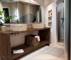 a bathroom with two sinks and a large mirror over it's counter top,