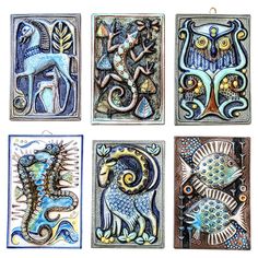 four tile paintings with different designs on them