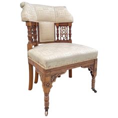 an old wooden chair with white upholstered fabric on the back and seat cushion