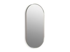 an oval mirror hanging on the wall