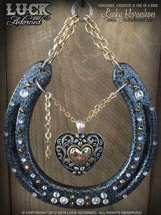 a necklace with a heart hanging from it's center and chains attached to it