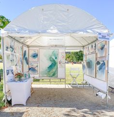 a white tent with paintings on it