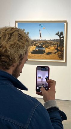 a man is looking at an image on his cell phone