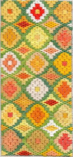 a green and yellow rug with flowers on it