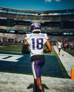 a football player is walking on the field