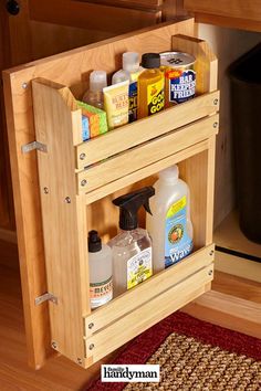 a wooden cabinet with two shelves holding cleaning products and other household care items in it