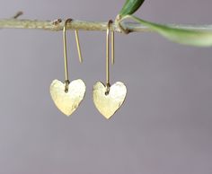 "You will receive one pair of brass earrings from my brass jewelry collection. You can see the whole collection here: https://www.etsy.com/shop/ARTISUNtis?ref=seller-platform-mcnav§ion_id=42470765 * Heart earrings with tiny textured heart/15 mm/ * hammered earrings - hammered by hand for texture and unique pattern design * lightweight earrings - it is a pleasure to wear them * minimalist earrings - simple, but elegant design * everyday earrings and for special occasions * Perfect gift - suitable for gift to you or to the special one in your life * including \"care instructions\" * raw brass ear wire hook earrings About material: Brass is a sturdy metal - combination of zinc and copper.  For that reason will naturally tarnish when exposed to oxygen.  Often used in fashion jewelry, brass doe Handmade Brass Earrings For Valentine's Day, Handmade Brass Heart Dangle Earrings, Heart Charm Brass Earrings As Gift, Brass Heart Charm Earrings For Gifts, Brass Heart Charm Earrings As Gift, Nickel Free Gold Brass Heart Earrings, Nickel-free Gold Heart Earrings In Brass, Nickel-free Gold Heart Brass Earrings, Nickel-free Gold Brass Heart Earrings