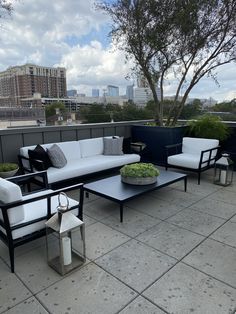 an outdoor seating area with white and black furniture