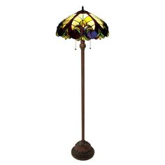 a floor lamp with a stained glass shade on the top and bottom part of it