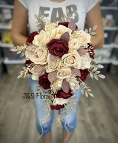 a woman holding a bouquet of flowers in her hands