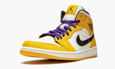 The Air Jordan 1 Mid “Lakers” is a special edition of the mid-top Jordan 1 inspired by the Los Angeles Lakers.  The Jordan 1 Mid is outfitted in the team colors of the team Michael Jordan and the Chicago Bulls defeated in the 1991 NBA Finals.  The Air Jordan 1 features a white leather base with University Gold full-grain leather overlays and a black Swoosh and inner lining.  Purple laces are added to complete the Lakers look.  The Air Jordan 1 Mid “Lakers” released in early 2019. Air Jordan 1 Mid Se, Jordan 8, Air Jordan 1 High, Purple Lace, Nba Finals, Jordan 1 High, Air Jordan 1 Low, Jordan 1 Low, Air Jordan 1 Mid