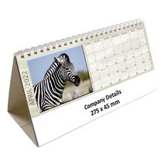 a desk calendar with a photo of a zebra