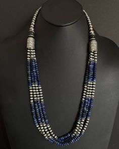 This beautiful multi-strand necklace features genuine lapis and sterling silver pearls beads, strung on a sturdy sterling silver chain. The necklace measures 30 inches in length and is perfect for adding a touch of Southwestern style to any outfit. The combination of the deep blue lapis and the oxidized pearls creates a stunning contrast that is sure to turn heads. The necklace is of high-quality .925 sterling silver and is suitable for daily wear. The beaded design gives it a unique look that i Cheap Silver Multi-strand Beaded Necklaces, Silver Multi-strand Beaded Necklace With Gemstone Beads, Silver Multi-strand Beaded Necklaces With Gemstone Beads, Silver Multi-strand Beaded Necklaces With Natural Stones, Silver Hand-strung Multi-strand Necklaces, Silver Lapis Lazuli Gemstone Beads Necklace, Silver Lapis Lazuli Jewelry With Polished Beads, Traditional Silver Lapis Lazuli Necklace, Traditional Silver Necklace With Lapis Lazuli