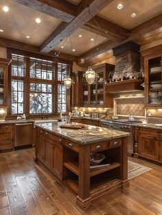 a large kitchen with wooden cabinets and marble counter tops, along with hardwood flooring