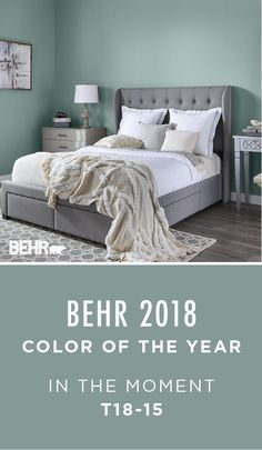 a bedroom with blue walls and white bedding in the foreground text reads behr 2018 color of the year in the moment