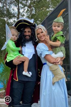 a man and woman dressed up as peter panton with two children