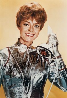 an autographed photograph of a woman holding a knife and fork in her hand