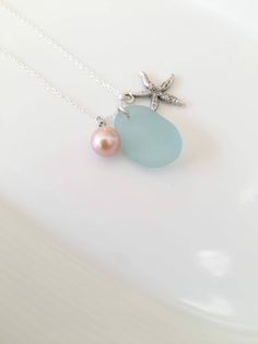 This beautiful Irish mermaid tear necklace is made with genuine sea foam blue sea glass found by me on the Wild Atlantic Way of Ireland. Amazing shapes, made by the Wild North Atlantic over decades and put together to complement each other as a dainty gift from the Mystical Emerald Island of fairies, leprechauns, elves and mermaids. Comes in an elegant jewellery box ready as a gift.  If you need a bigger quantity or any customized jewellery for your very special occasion (birthdays, weddings, bridal showers or any other event), please send me a message and I'll be glad to help. Ocean-inspired Sea Glass Necklaces For Beach, Blue Sea Glass Necklaces For Jewelry Making, Ocean-inspired Blue Sea Glass Necklaces, Irish Mermaid, Blue Sea Glass Necklace, Beach Glass Necklace, Mermaid Tears, Wild Atlantic Way, Elegant Jewellery