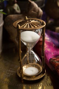 an hourglass sitting on top of a table