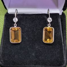 Very Pretty, 14.50ctw Emerald Cut Brazilian Citrine With .50ctw Round White Topaz Rhodium Over Sterling Silver Dangle Earrings. Measures Approximately 1.25"L X 0.44"W. Lever Backs. Listed On Jtv For $60 Currently, Certainly Dress Up Or Dress Down Earrings Box Only For Display Purposes! Black Stone Earrings, Earring Box, Coin Pearls, Jtv Jewelry, Climber Earrings, Coral Earrings, Ear Cuff Earings, Silver Dangle Earrings, Sterling Silver Dangle Earrings